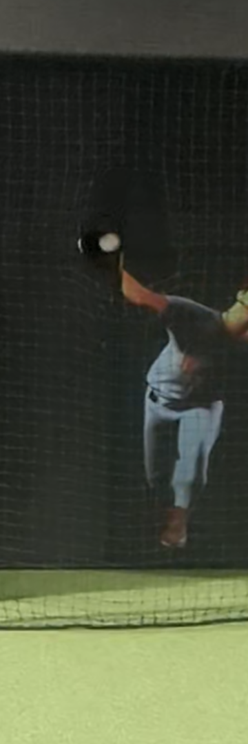 Pitcher mid-windup on simulator screen